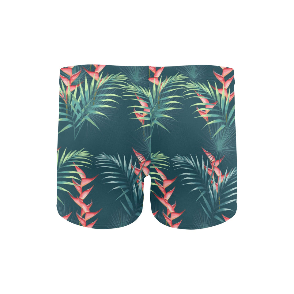 heliconia flowers, palm and monstera leaves on bla Men's Swimming Trunks