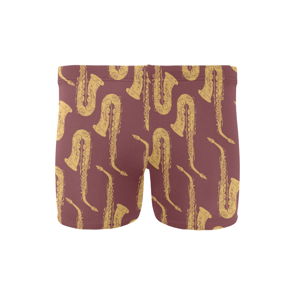 Hand drawn gold saxophone red background Men's Swimming Trunks