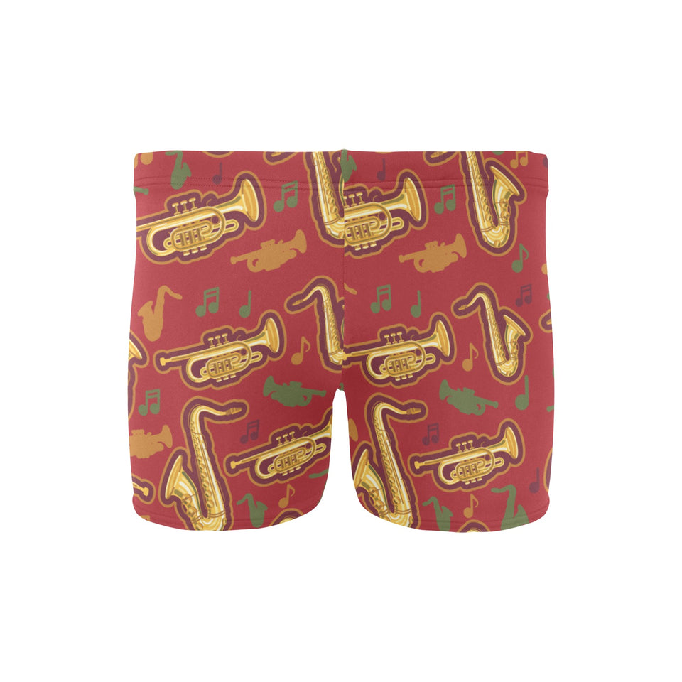 Saxophone cornet pattern red background Men's Swimming Trunks