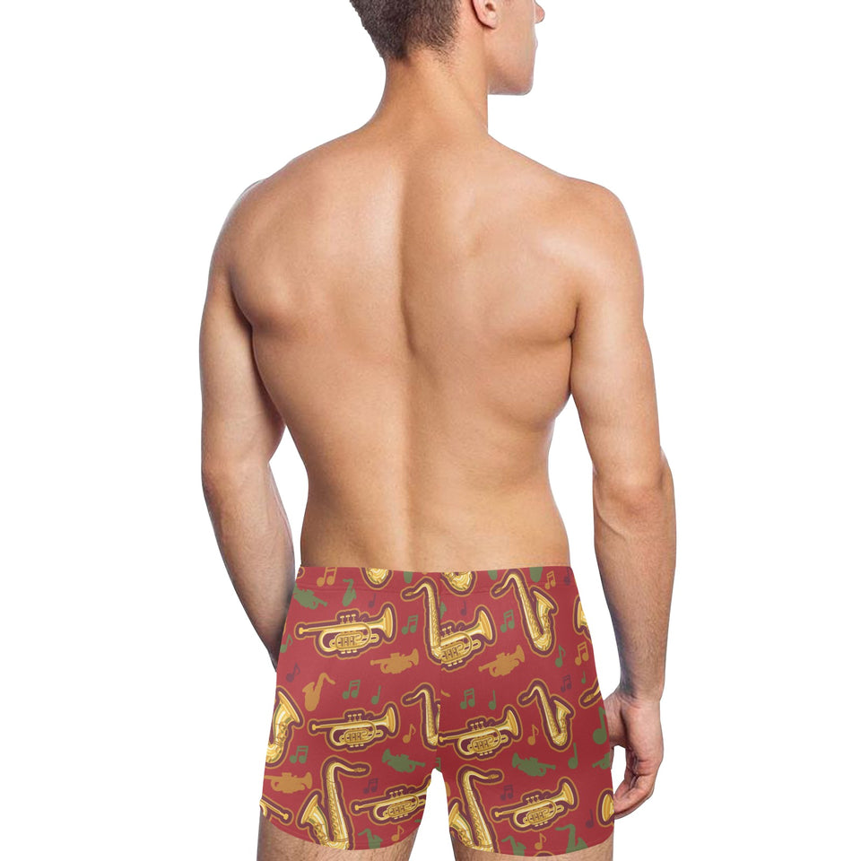 Saxophone cornet pattern red background Men's Swimming Trunks