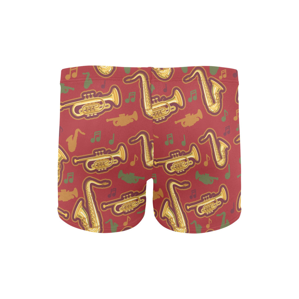 Saxophone cornet pattern red background Men's Swimming Trunks