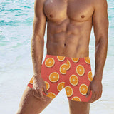 Oranges pattern red background Men's Swimming Trunks