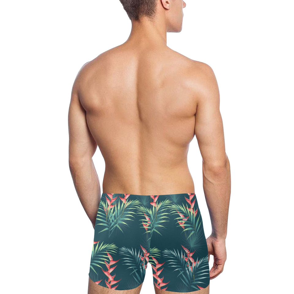 heliconia flowers, palm and monstera leaves on bla Men's Swimming Trunks