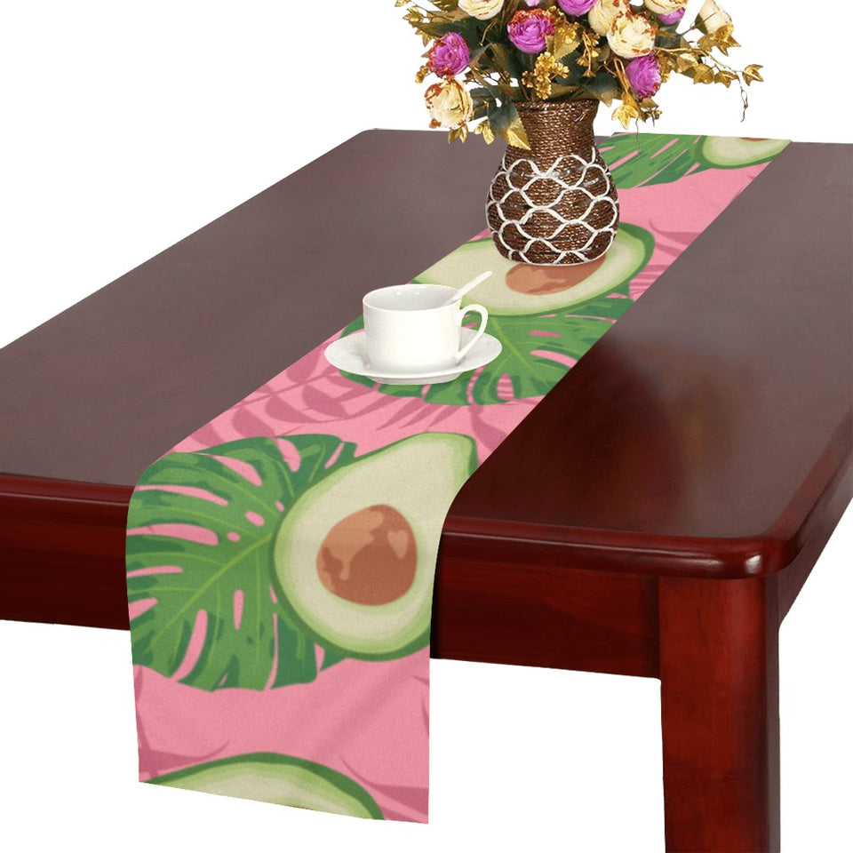 Avocado slices leaves pink back ground Table Runner