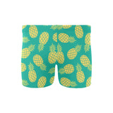 Pineapples pattern green background Men's Swimming Trunks