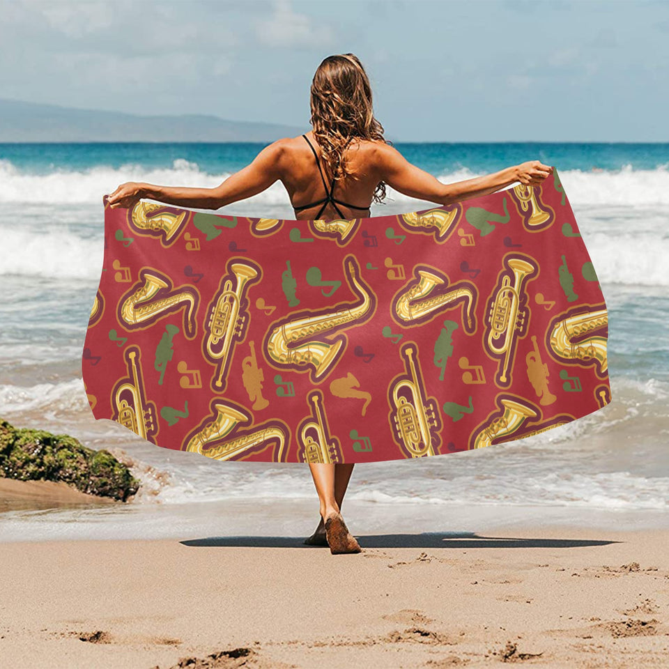 Saxophone cornet pattern red background Beach Towel