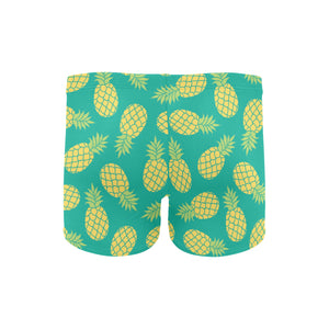 Pineapples pattern green background Men's Swimming Trunks