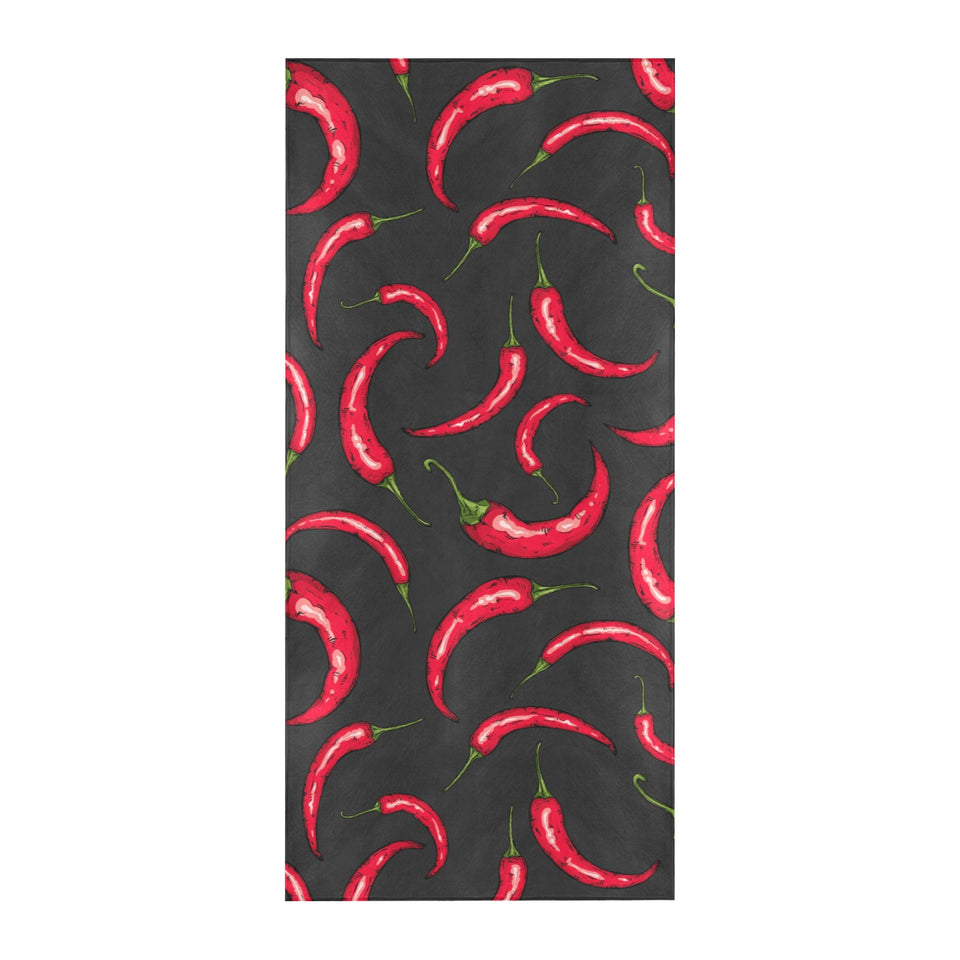 Chili peppers pattern black background Beach Towel