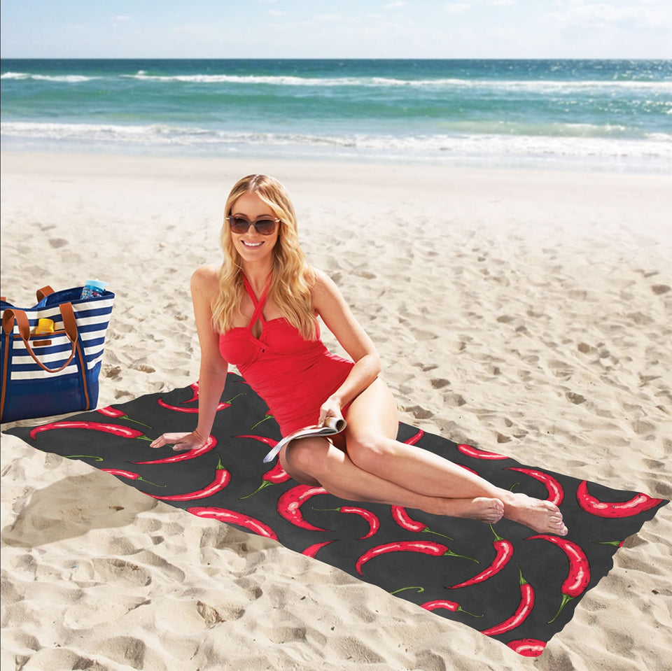 Chili peppers pattern black background Beach Towel