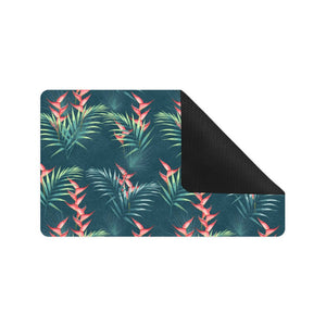 heliconia flowers, palm and monstera leaves on bla Doormat