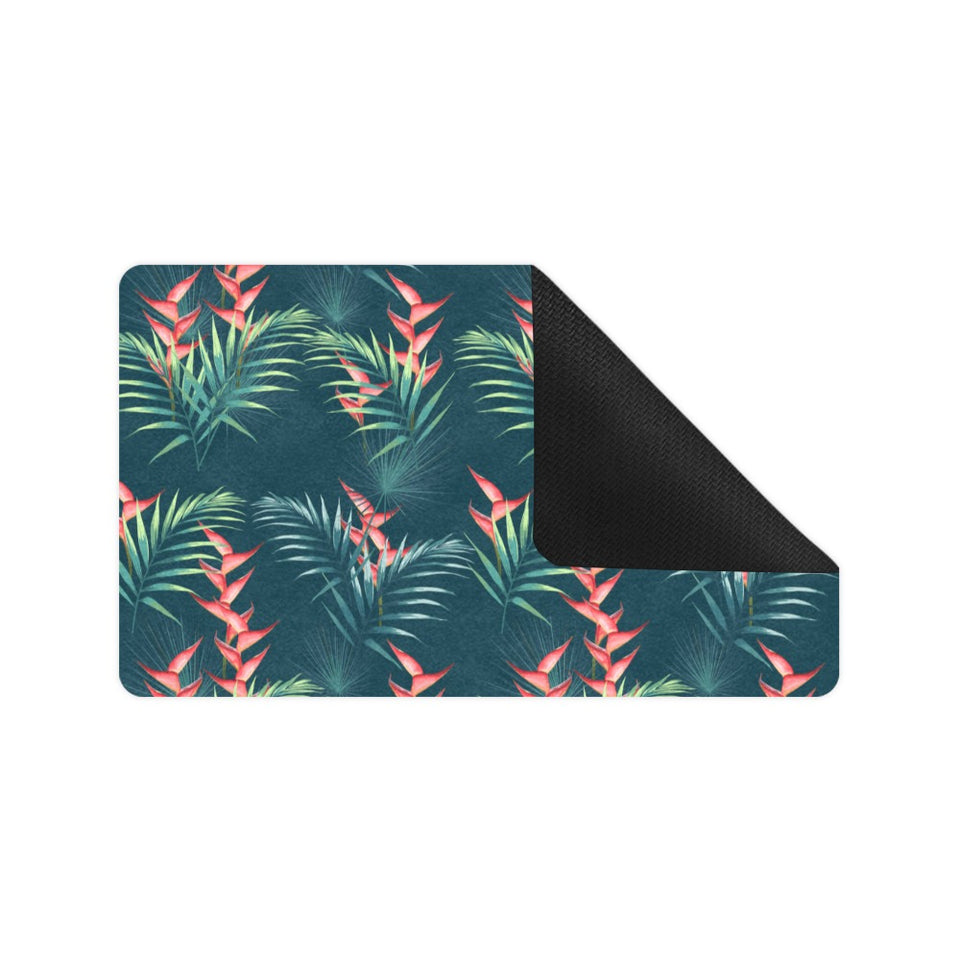 heliconia flowers, palm and monstera leaves on bla Doormat