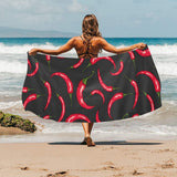 Chili peppers pattern black background Beach Towel