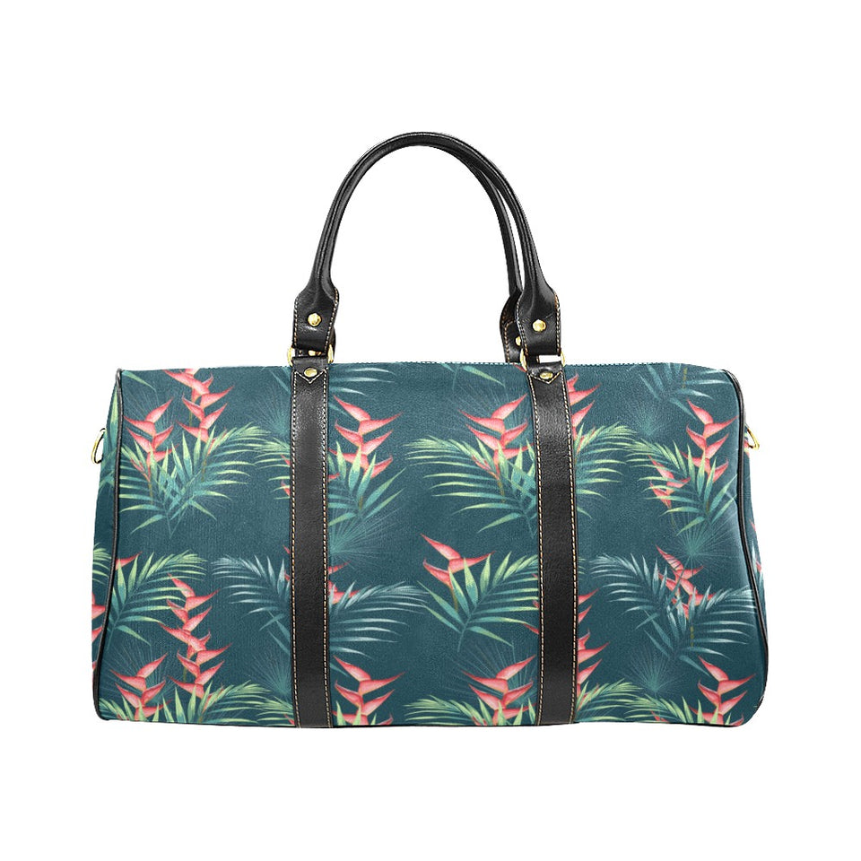 heliconia flowers, palm and monstera leaves on bla Travel Bag