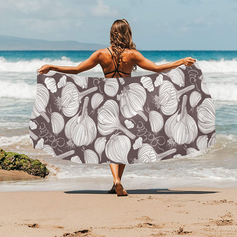 Garlic bulb dark background Beach Towel