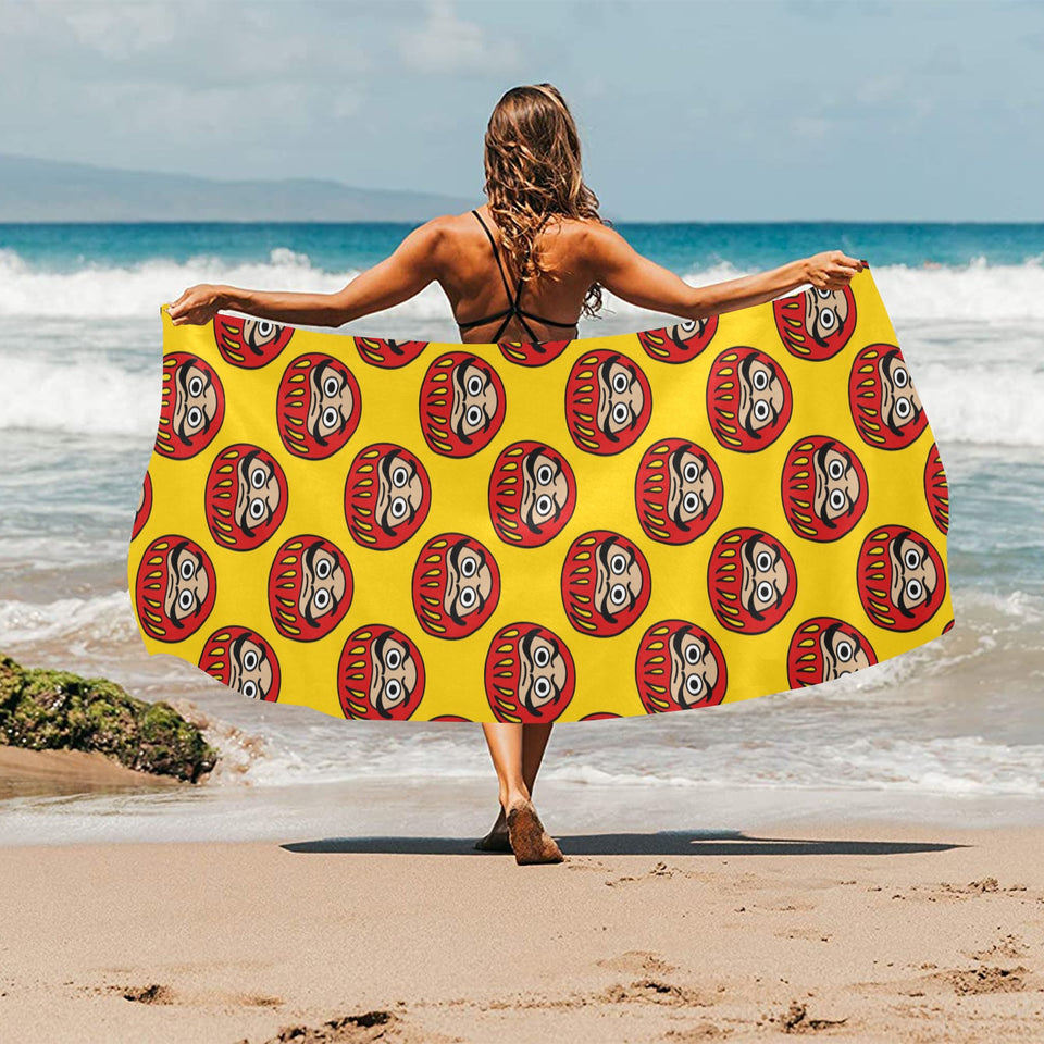 Daruma japanese wooden doll yellow background Beach Towel