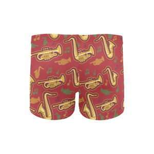 Saxophone cornet pattern red background Men's Swimming Trunks