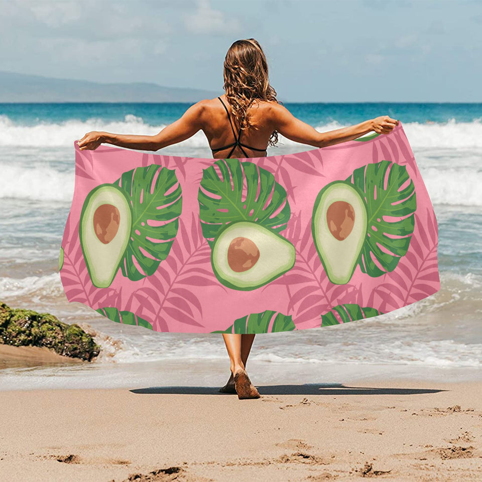 Avocado slices leaves pink back ground Beach Towel