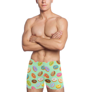 Colorful donut pattern green background Men's Swimming Trunks