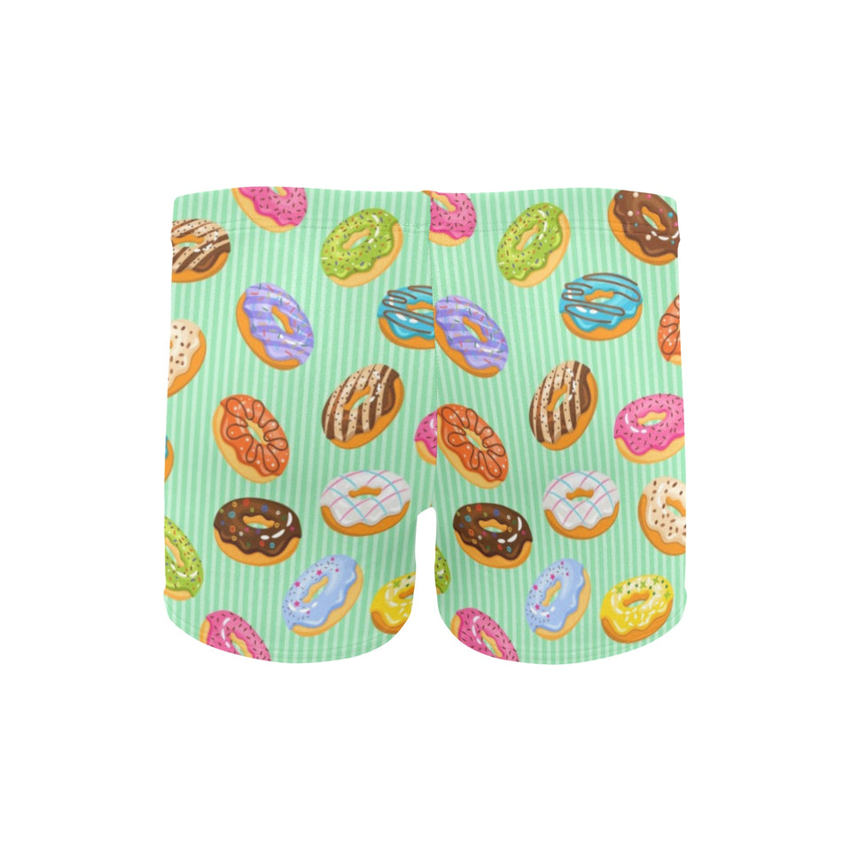 Colorful donut pattern green background Men's Swimming Trunks