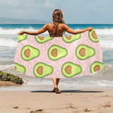 Avocado heart pink background Beach Towel
