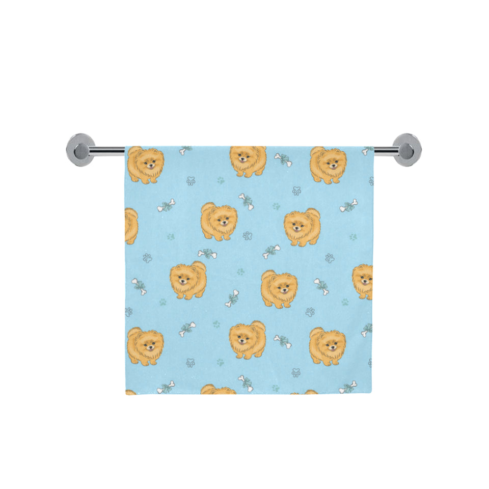 Brown cute pomeranian blue blackground Bath Towel