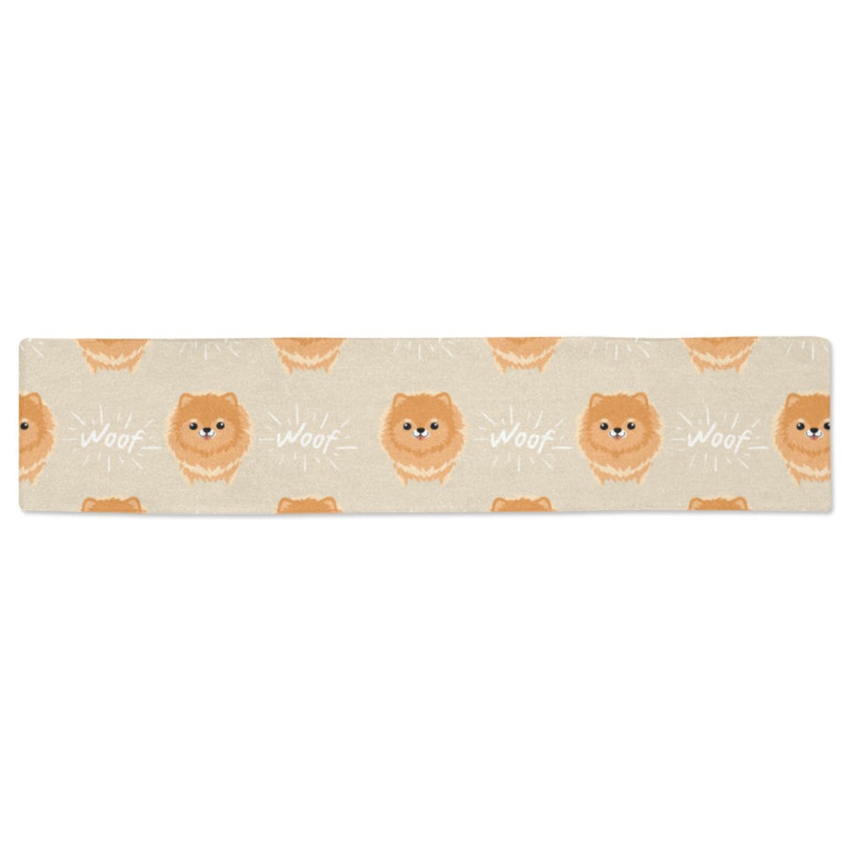 Cute brown pomeranian puppy on blue Table Runner