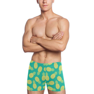 Pineapples pattern green background Men's Swimming Trunks