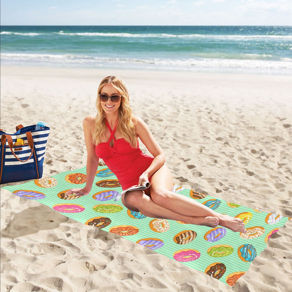 Colorful donut pattern green background Beach Towel