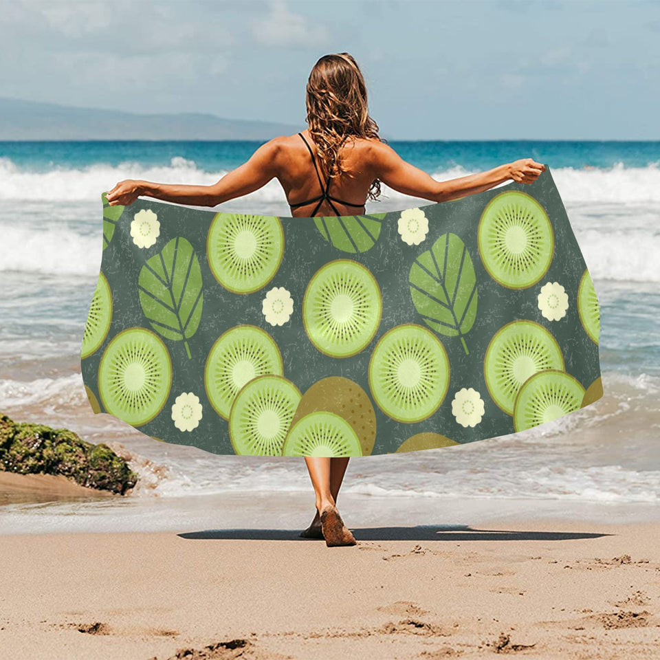 Whole sliced kiwi leave and flower Beach Towel